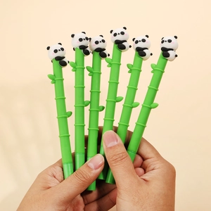 Close-up of a hand holding cute panda bamboo gel pens with green jointed barrels