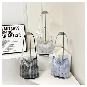 Three bucket bags in black, blue, and white with polka dots and lace bow detail