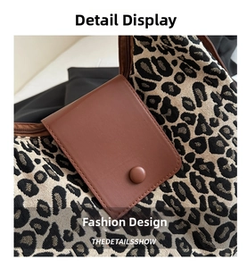 Detail of leopard print fabric texture and brown leather flap with matte round button