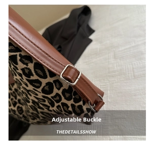 Detail of adjustable metal buckle and leopard print canvas on large tote bag