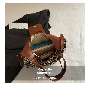 Detail shot of leopard print tote bag interior showing spacious storage for laptop and books
