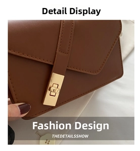 Detail of vintage brown leather crossbody bag featuring a golden twist-lock closure