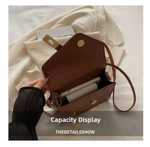 Internal storage view of brown leather crossbody bag with smartphone and wallet