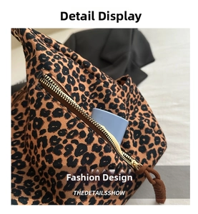Detailed close-up of leopard print canvas bag featuring a functional metal zipper pocket