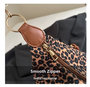Close-up of leopard print tote with brown litchi grain leather and gold metal zipper