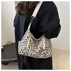 Retro leopard print tote bag with woven wide strap shown from a stylish side view angle