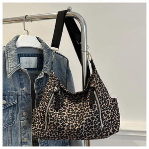Detailed leopard print tote bag with vertical zippers and black fabric shoulder strap