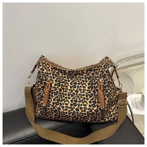 Detailed macro view of the leopard print canvas texture and vertical zipper pockets