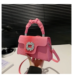 Pink faux leather crossbody bag with crocodile texture and square rhinestone buckle