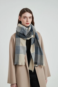 Detail of blue and beige plaid scarf with fringed edges on camel wool coat