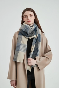 Detail of blue plaid scarf with soft fringe edges and thick wool texture