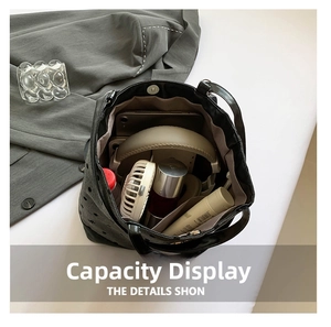 Spacious interior of black polka dot tote bag showing storage for tablet and gadgets