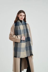 Detail of soft navy and beige checkered scarf with tassels on a wool coat