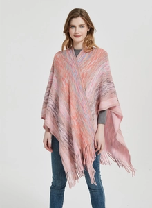 Close-up of multicolor gradient knit shawl featuring long fringe edges and soft texture