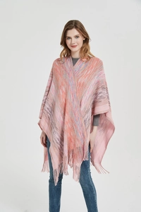 Detail of multi-color gradient knit poncho featuring long fringe trim and woven texture