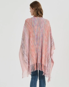 Rear view of a knit shawl with pink and purple gradient colors and tassel hem details