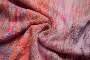 Detailed macro view of the colorful gradient knit fabric with soft textured fringe texture