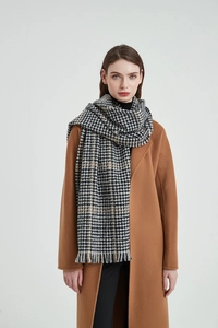 Detail shot of vintage houndstooth scarf with soft fringe and stylish wool-like texture