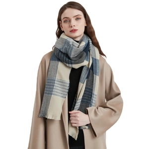 Thick soft blue plaid scarf for women with tassels paired with a wool coat for winter