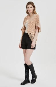 Detail of a brown and cream striped knit poncho with fringe edges and soft texture