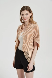 Detailed view of orange and white striped knitted shawl featuring soft fringe edges