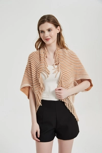Detail shot of striped knit shawl with long tassels and brown white patterns