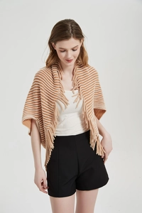 Close-up of striped knit shawl with fringe trim and brown and cream horizontal patterns