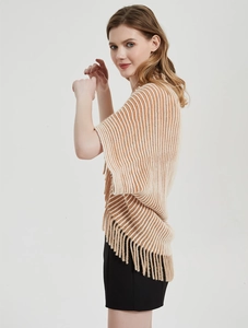 Detail of striped knit poncho for women featuring a draped fit and elegant tassel fringe