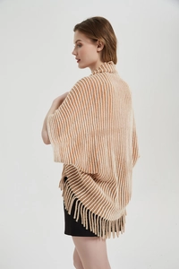 Detailed view of women's knit shawl featuring brown vertical stripes and elegant long fringe