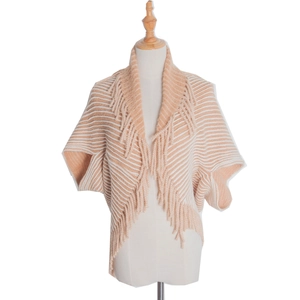 Detailed view of beige striped knit poncho featuring elegant long fringe decorative trim