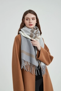 Close-up of grey and beige striped thick knit scarf with fringe detailing on casual coat