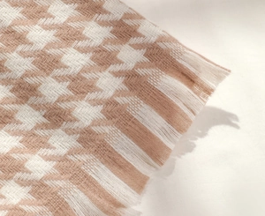 Gros plan d'une écharpe en maille à motif pied-de-poule avec des franges élégantes