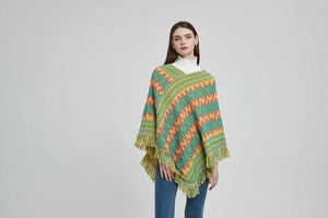 Close-up of bohemian knit shawl featuring vibrant wave patterns and fringe tassels