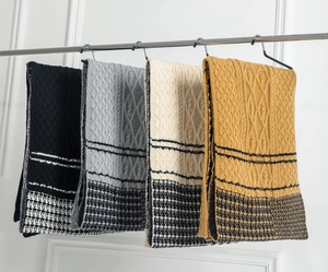 Detail showing knit scarves in black, grey, beige, and camel with houndstooth patterns