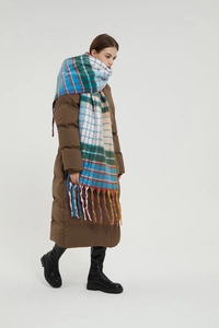 Close-up of thick winter rainbow checkered scarf with long tassels and oversized pattern