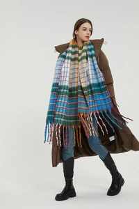 Detail of colorful rainbow plaid scarf with long fringes and thick mohair-like texture
