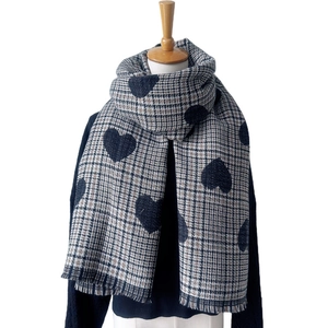 Winter checkered shawl with black heart pattern and fringed edges on mannequin