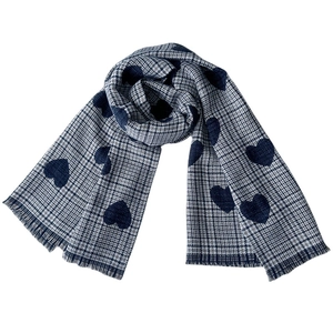 Detail of navy blue plaid scarf featuring large heart patterns and soft fringe edges