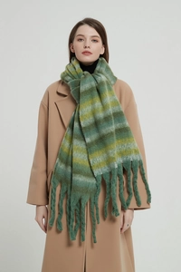 Detail of green and yellow striped chunky knit scarf with long thick tassels