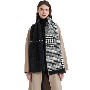 Thick knitted houndstooth infinity scarf with mixed patterns worn on camel coat