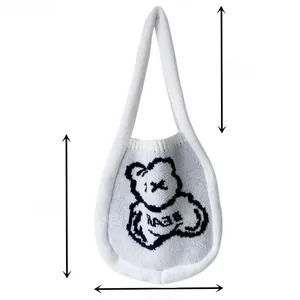 Detailed dimension guide for white knitted tote bag with black bear pattern and strap length