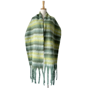 Detail of colorful striped thick knit scarf with long fluffy tassels on a mannequin