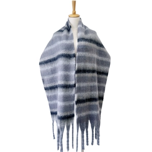 Detail of thick striped scarf with long fringe and textured loop yarn fabric in grey and navy
