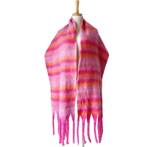 Detail of multi-color striped winter scarf featuring chunky tassels and boucle yarn texture