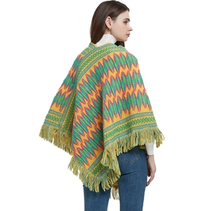 Ethnic knit poncho featuring colorful zigzag patterns and tassel fringe details