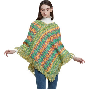 Ethnic knit poncho cape with bohemian colorful wave patterns and tassel hem for women
