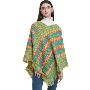 Ethnic bohemian style knit poncho with colorful geometric patterns and long tassels