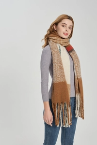 Detailed view of winter oversized plaid scarf with long tassels and chunky knit texture