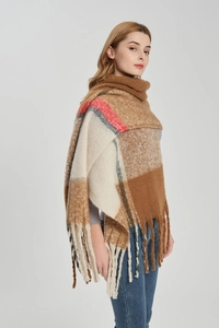 Detail of colorful oversized plaid scarf with chunky tassels and thick fuzzy texture