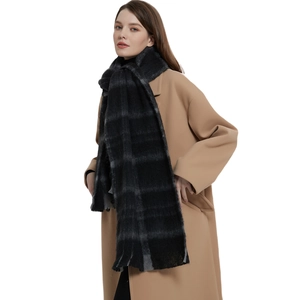 Classic black and grey checkered knit scarf with tassels for winter fashion style